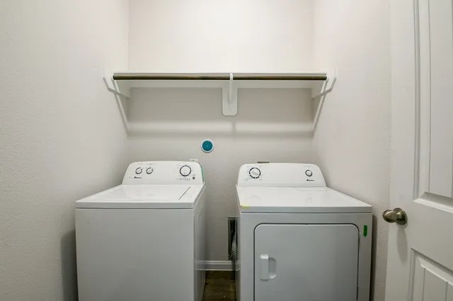 a view of a house with a yard and wooden fence