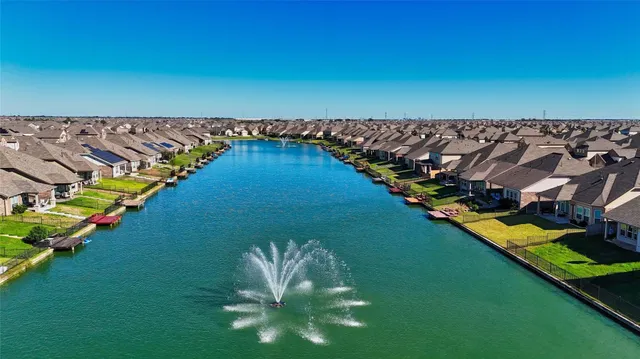 a view of a house with pool and a lake view
