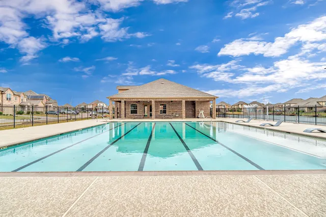 a view of house with swimming pool outdoor seating