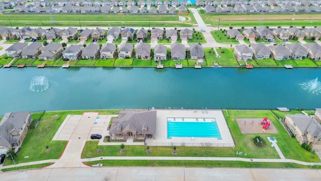 a kitchen with stainless steel appliances granite countertop a refrigerator a sink dishwasher a stove and white countertops with wooden floor