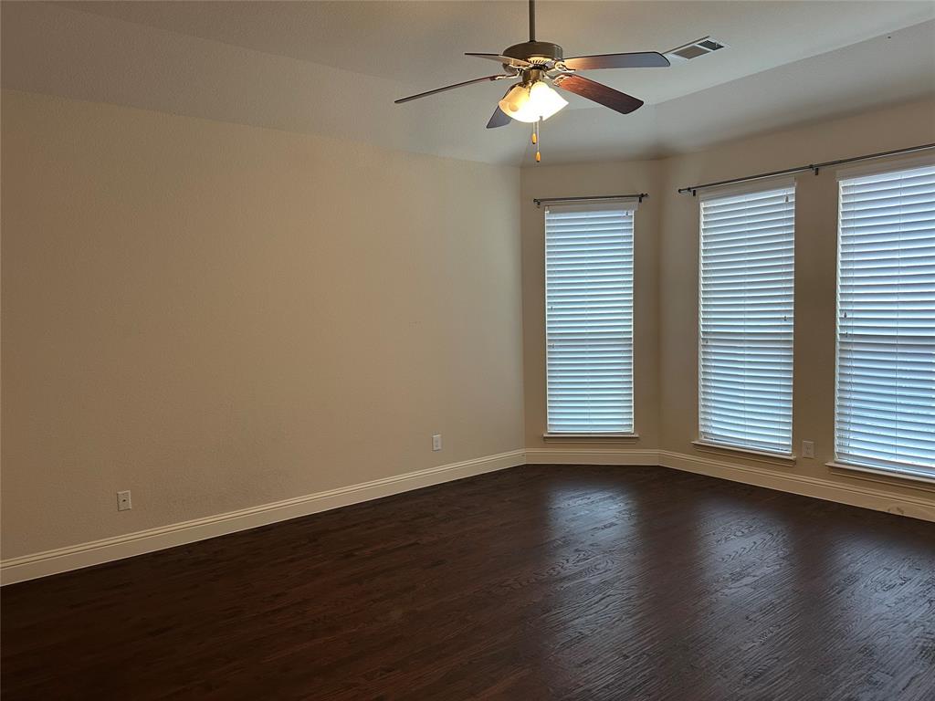 16207 Mapleshade Drive Frisco, TX 75035 - Photo 1 of 16 Spare room with ceiling fan, baseboards, visible vents, and dark wood finished floors