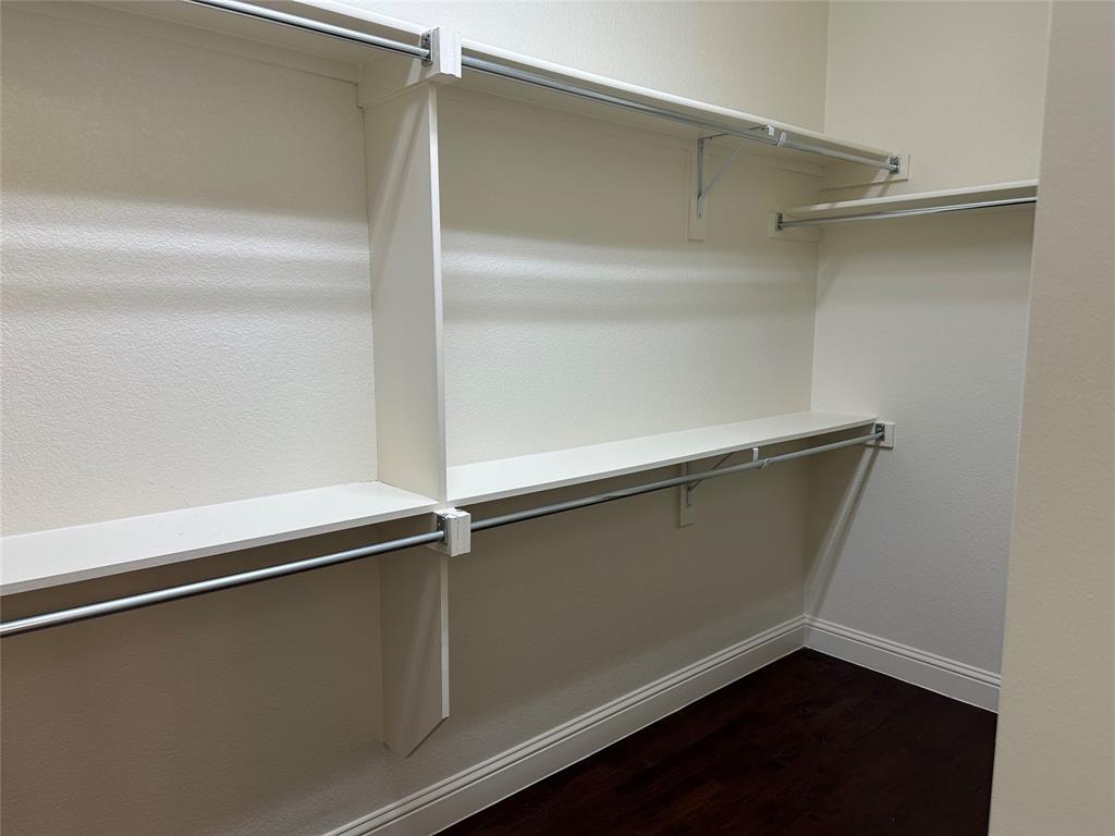 16207 Mapleshade Drive Frisco, TX 75035 - Photo 2 of 16 Walk in closet featuring dark wood-style flooring