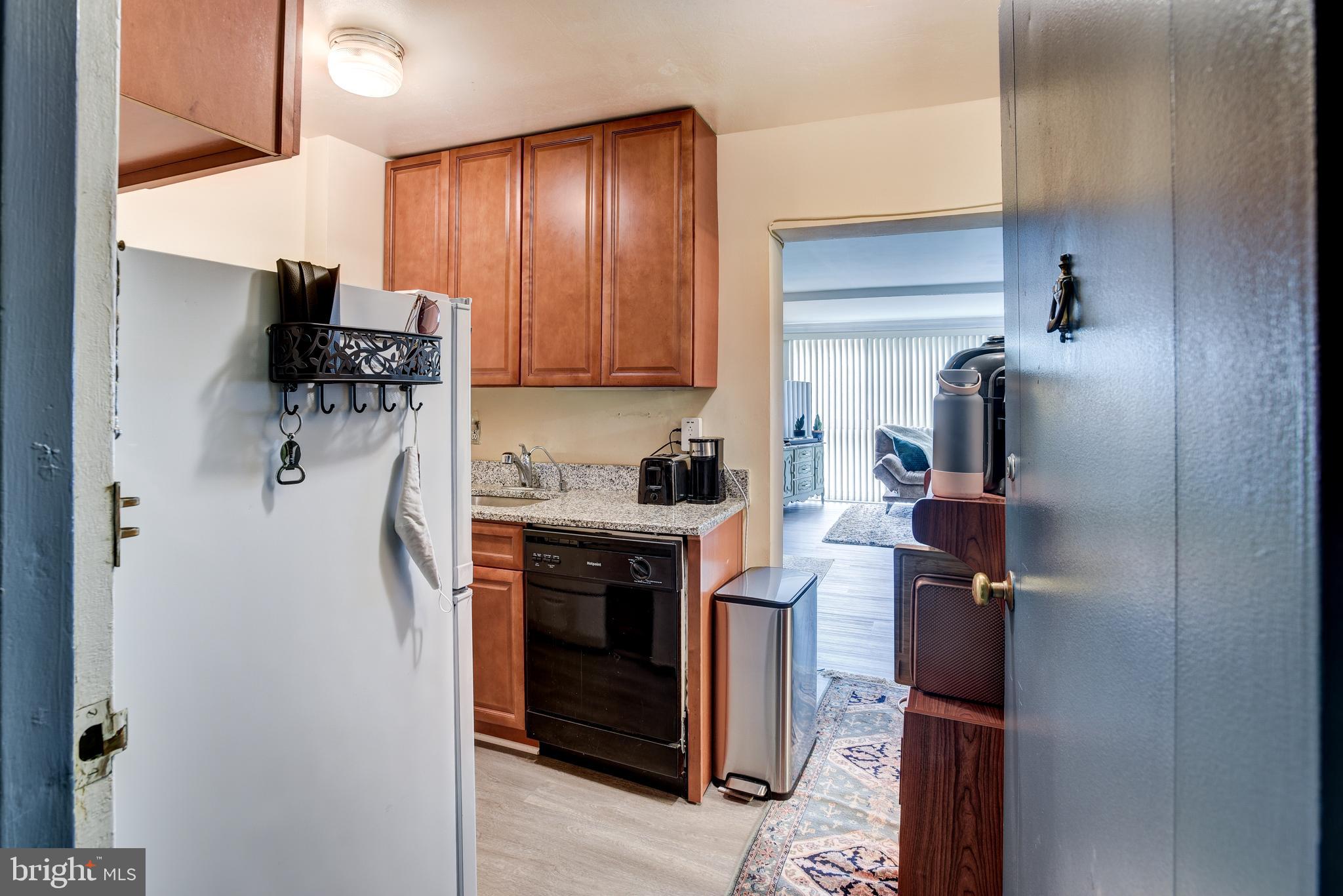 922 24th Street Northwest, Unit 115 Washington, DC 20037 - Photo 13 of 43 a kitchen with stainless steel appliances granite countertop a refrigerator and a stove top oven