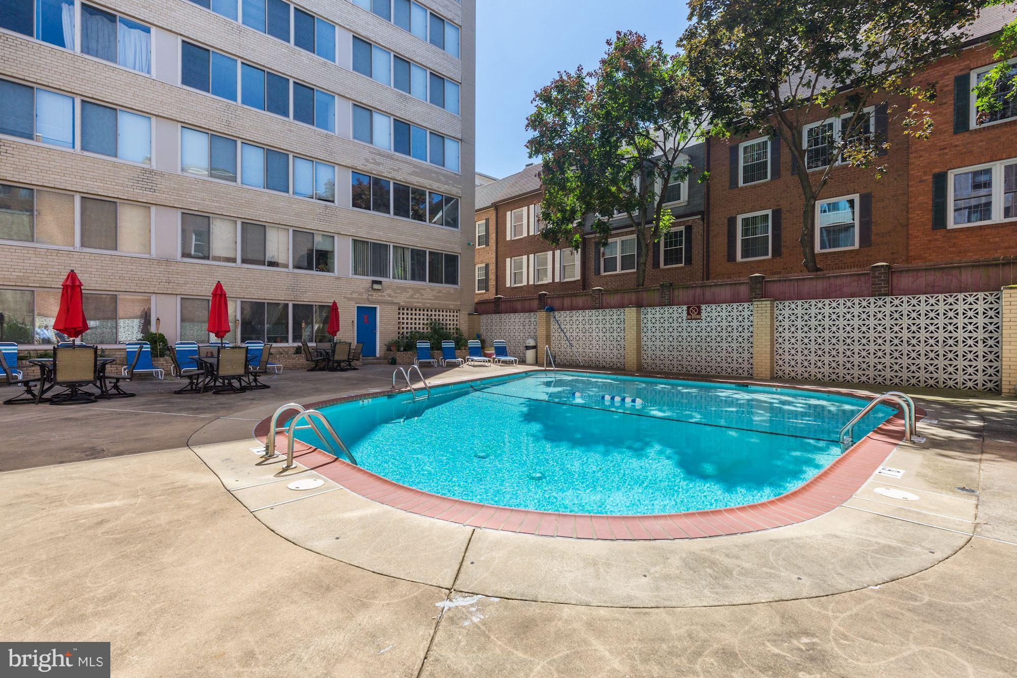 922 24th Street Northwest, Unit 115 Washington, DC 20037 - Photo 30 of 43 a view of a swimming pool with a lounge chairs
