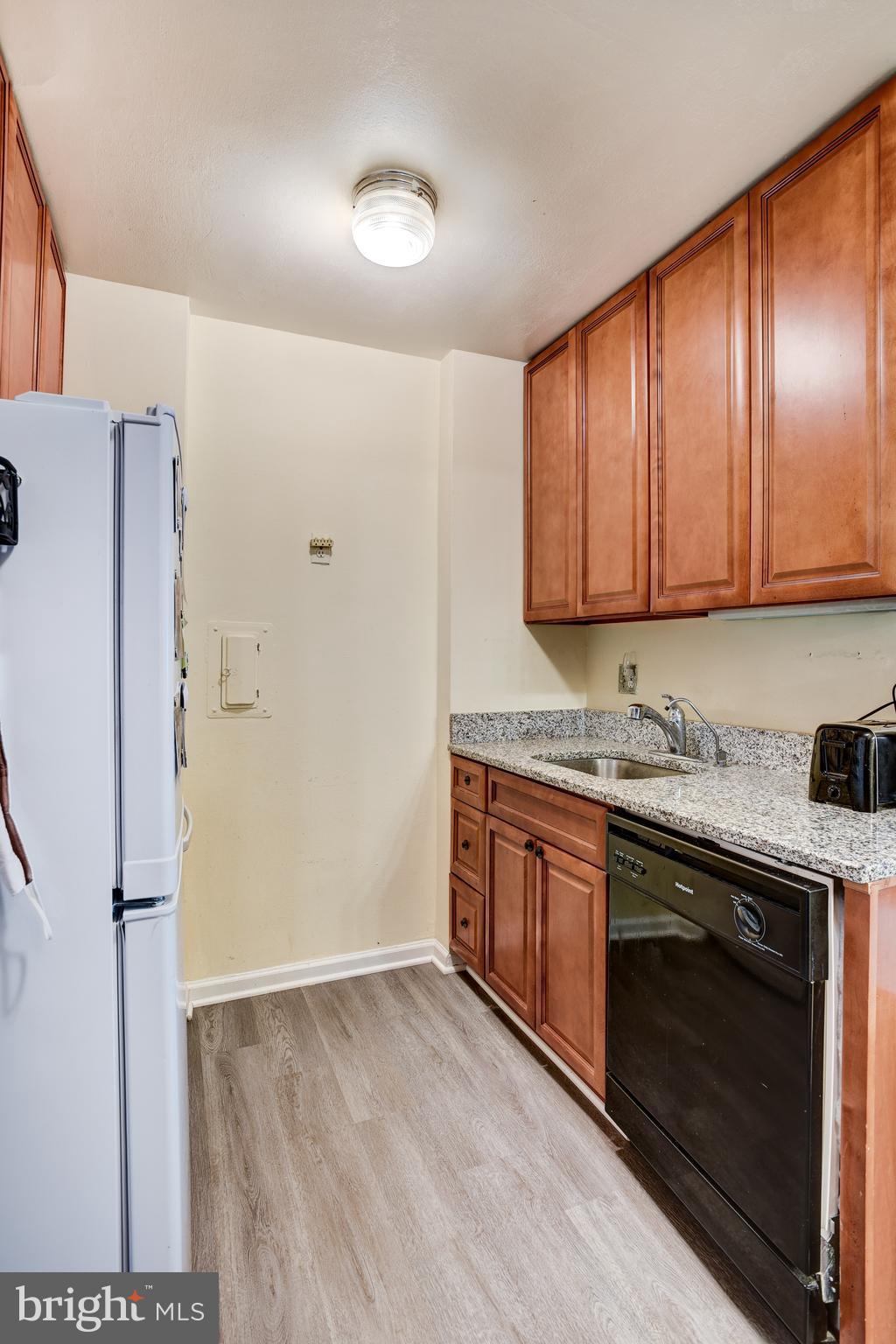 922 24th Street Northwest, Unit 115 Washington, DC 20037 - Photo 8 of 43 a kitchen with stainless steel appliances granite countertop a stove a sink and a refrigerator