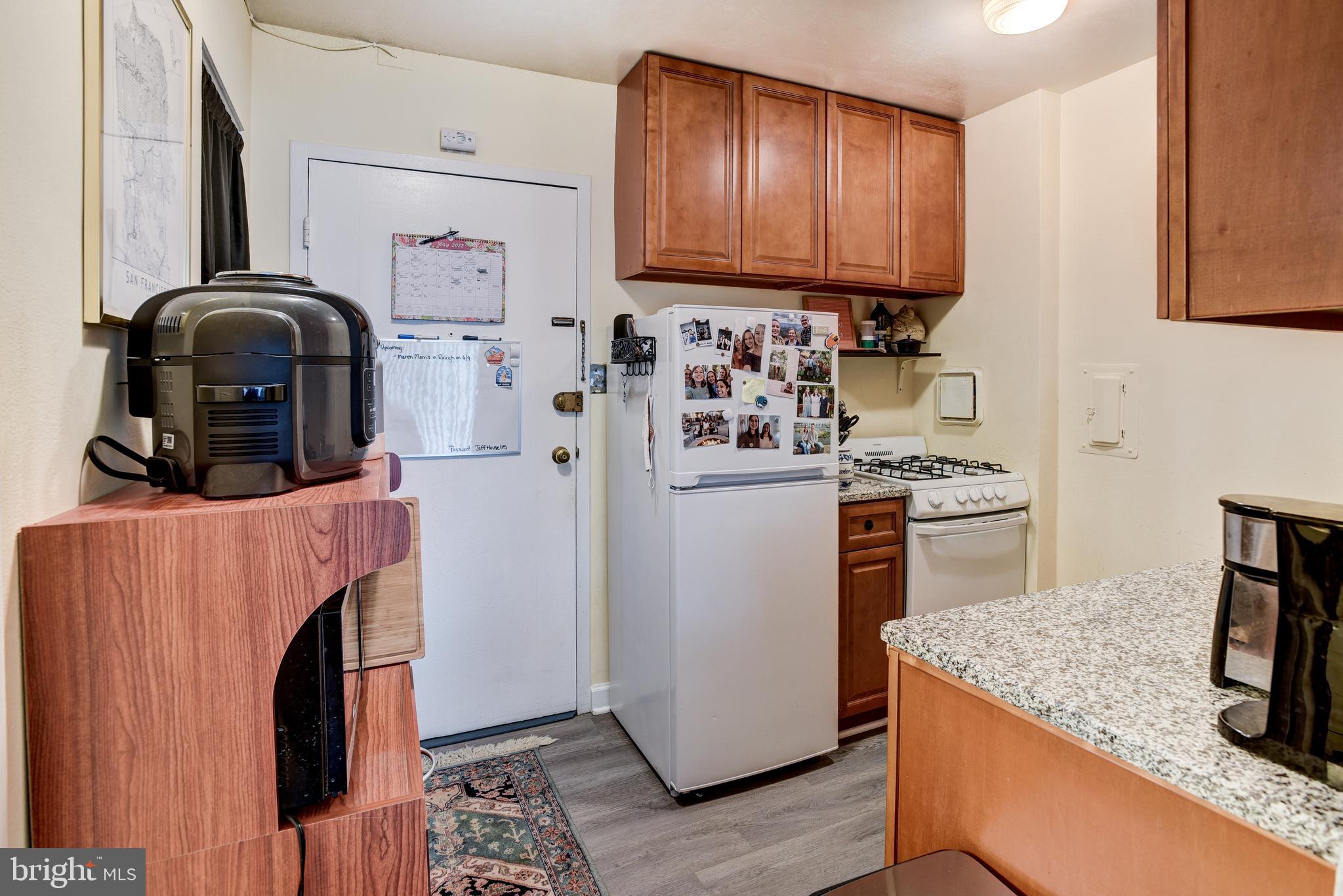 922 24th Street Northwest, Unit 115 Washington, DC 20037 - Photo 9 of 43 a kitchen with stainless steel appliances granite countertop a refrigerator and a stove top oven