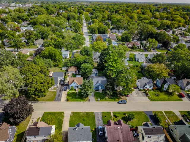 an aerial view of a houses with yard