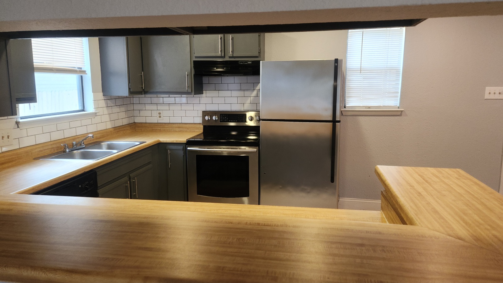 2807 West Slaughter Lane, Unit B Austin, TX 78748 - Photo 12 of 12 a kitchen with stainless steel appliances granite countertop a refrigerator and a sink
