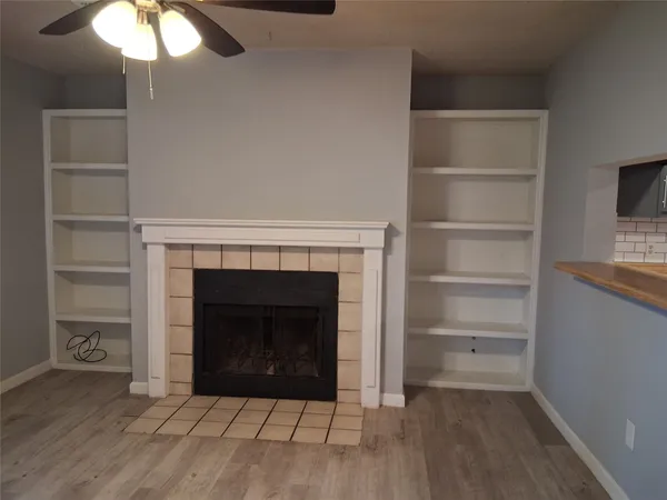 a room with a fireplace and a chandelier