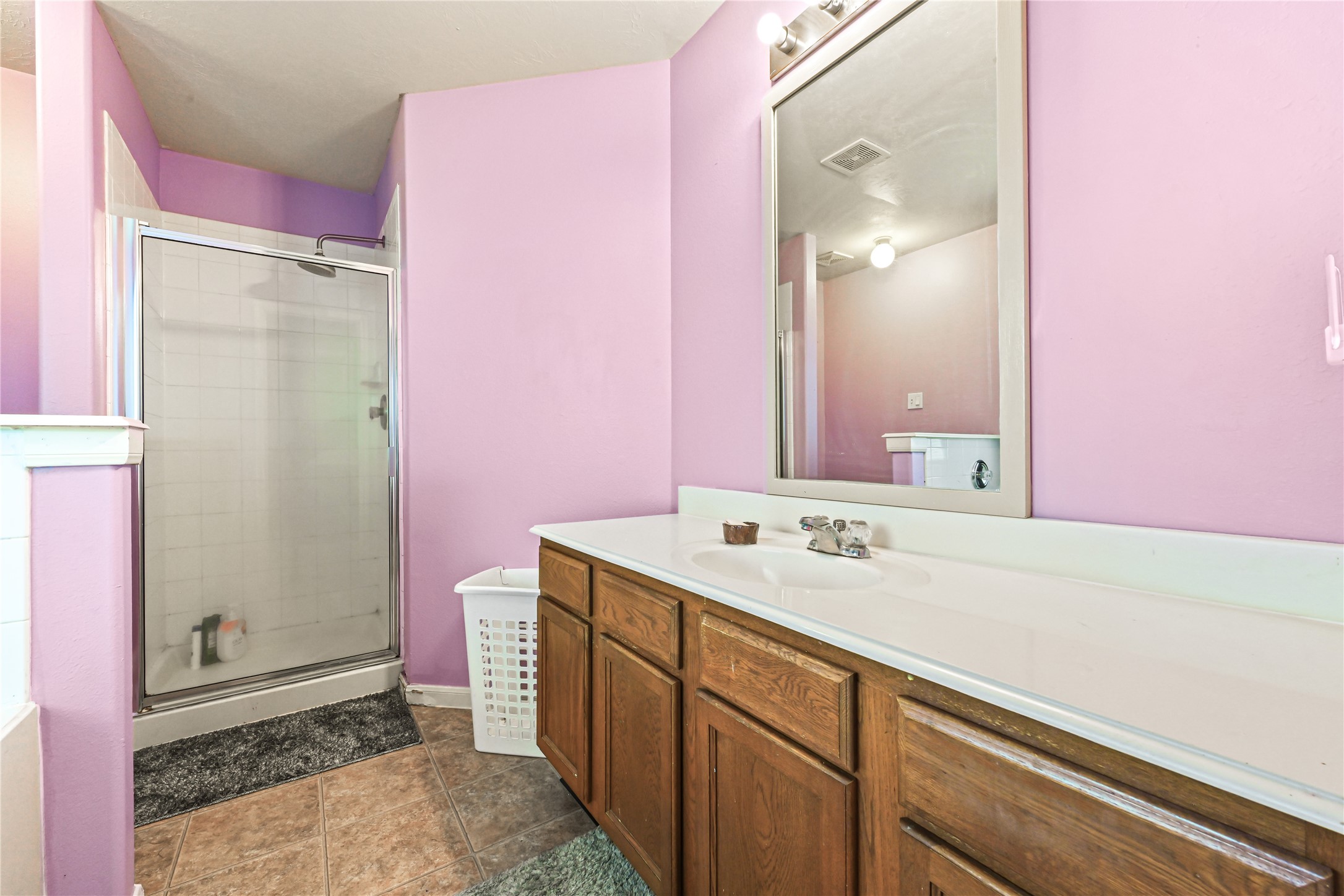 3726 Forney Ridge Lane Houston, TX 77047 - Photo 16 of 25 Primary bathroom featuring dual sinks, vanity storage, and soaking tub.
