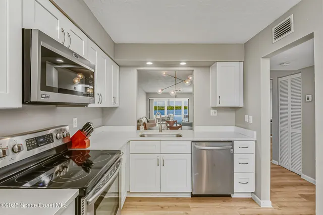 a kitchen with a stove a sink and a microwave