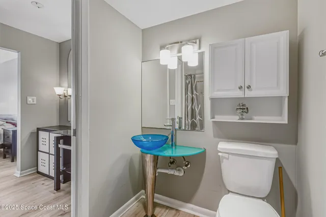 a bathroom with a toilet a sink and a shower