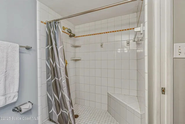 a bathroom with a shower and a glass door