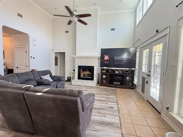a living room with furniture a flat screen tv and a fireplace