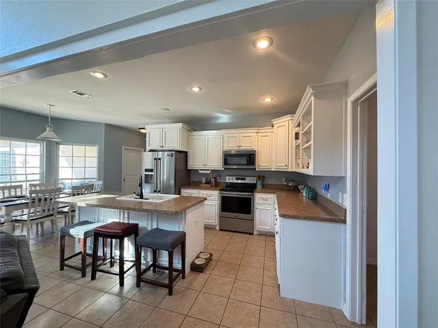 a view of a dining room with furniture wooden floor and chandelier