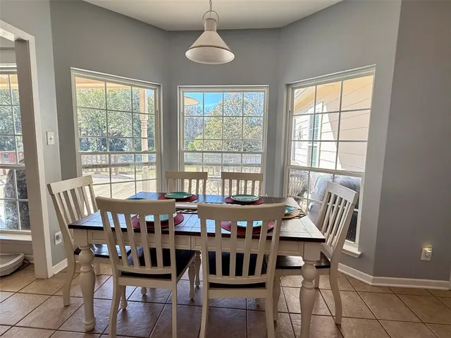 a bedroom with a large bed chandelier and a window