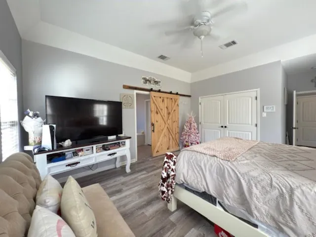 a spacious bedroom with a large bed and a window