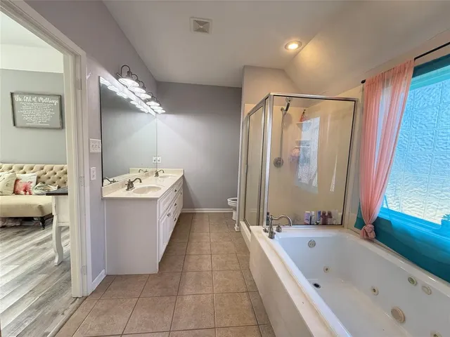 a bathroom with a tub and a shower