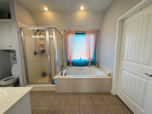 a bathroom with a tub a sink and mirror