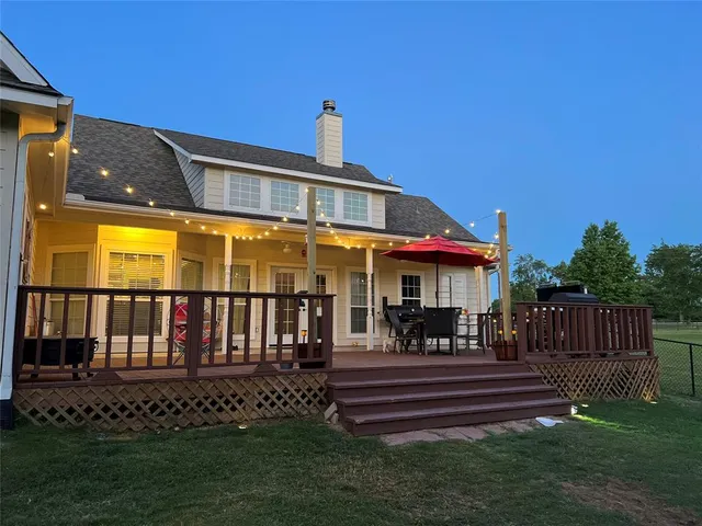 a view of a patio with a table and chairs under an umbrella