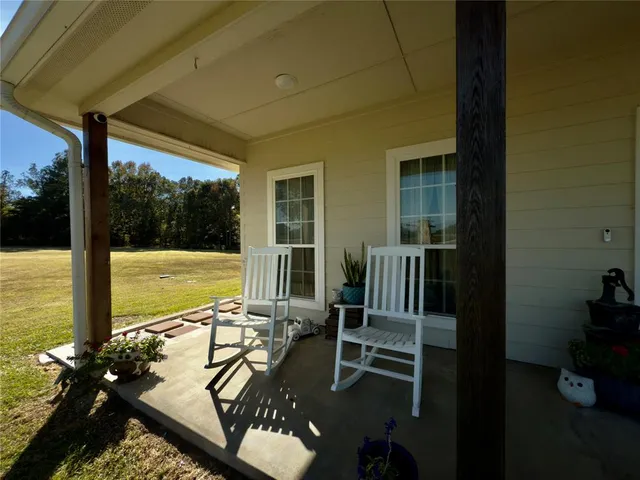 a view of a balcony with chair and floor to ceiling window