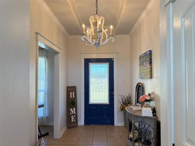 a view of a chandelier and a livingroom with furniture
