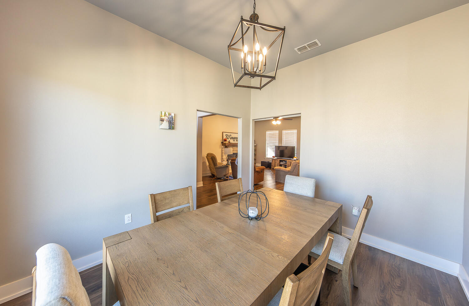 6961 103rd Street Lubbock, TX 79424 - Photo 13 of 32 a view of a dining room with furniture and wooden floor