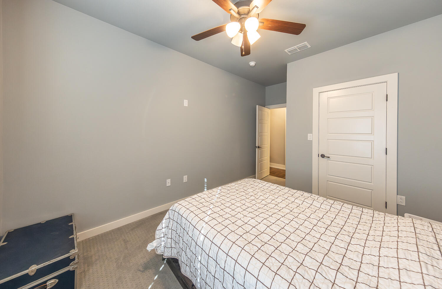 6961 103rd Street Lubbock, TX 79424 - Photo 15 of 32 a bedroom with a bed and a chandelier