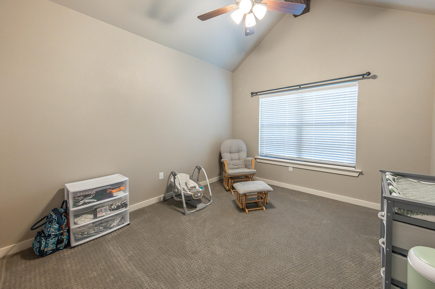 6961 103rd Street Lubbock, TX 79424 - Photo 17 of 32 a living room with furniture a chandelier and a window