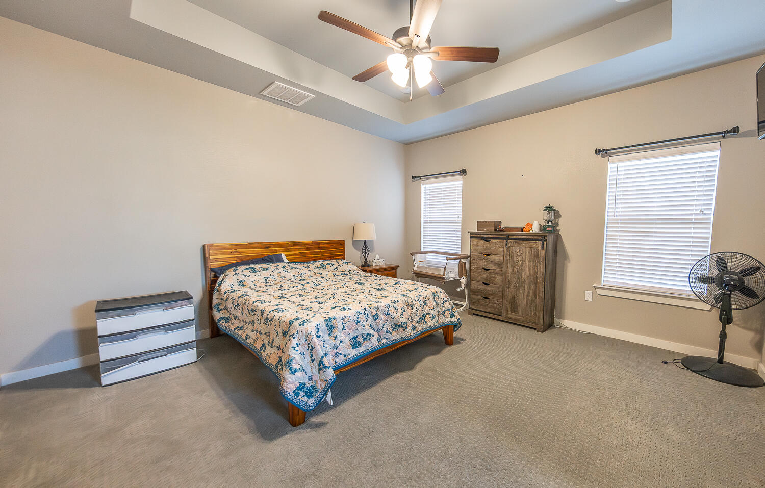 6961 103rd Street Lubbock, TX 79424 - Photo 18 of 32 a bedroom with a bed and ceiling fan