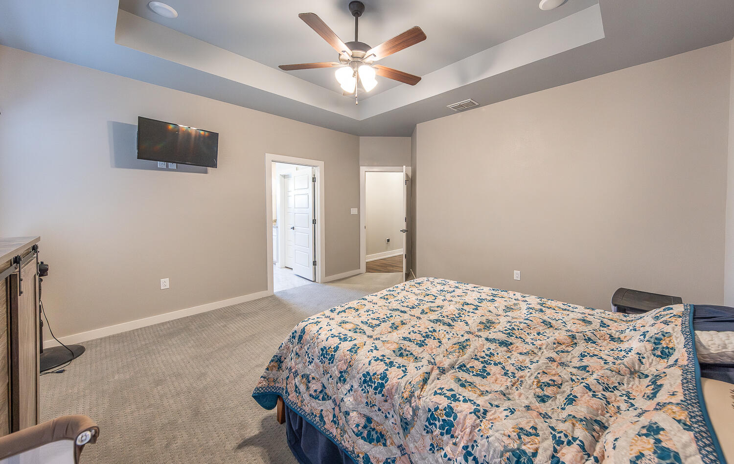 6961 103rd Street Lubbock, TX 79424 - Photo 19 of 32 a bedroom with a bed and a chandelier