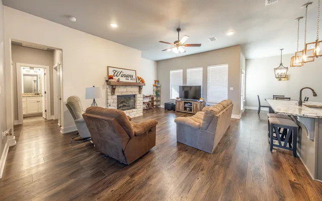 a living room with furniture and a wooden floor
