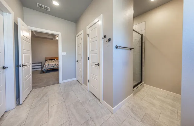 a view of a hallway with a livingroom and a bathroom