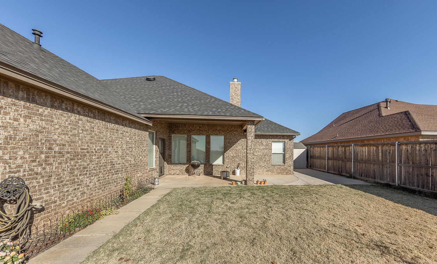 6961 103rd Street Lubbock, TX 79424 - Photo 25 of 32 a front view of a house with a yard