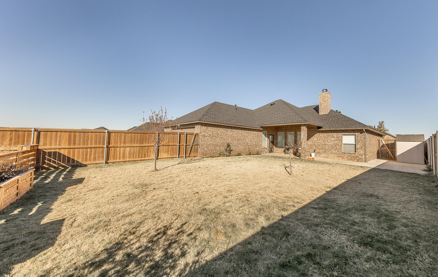 6961 103rd Street Lubbock, TX 79424 - Photo 26 of 32 a view of a house with a yard