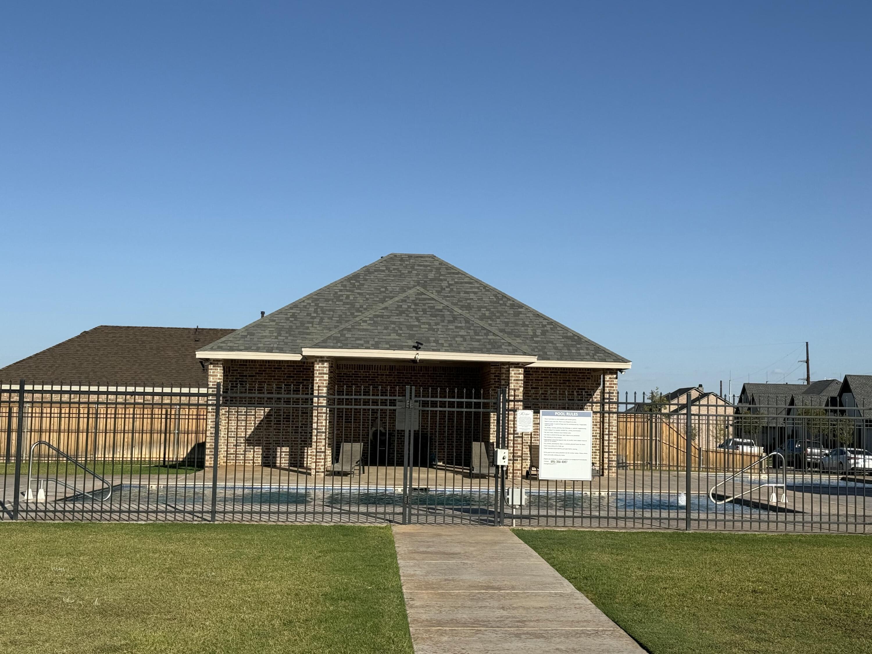 6961 103rd Street Lubbock, TX 79424 - Photo 31 of 32 a front view of a house with a garden and plants