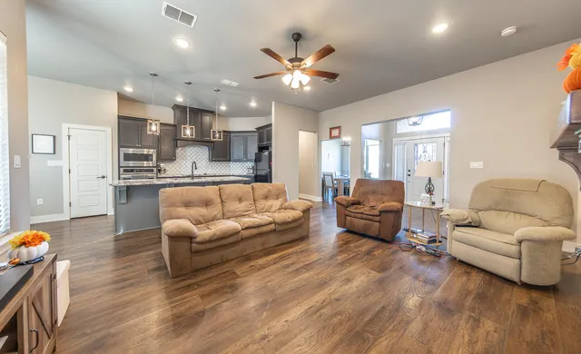 a living room with furniture and kitchen view