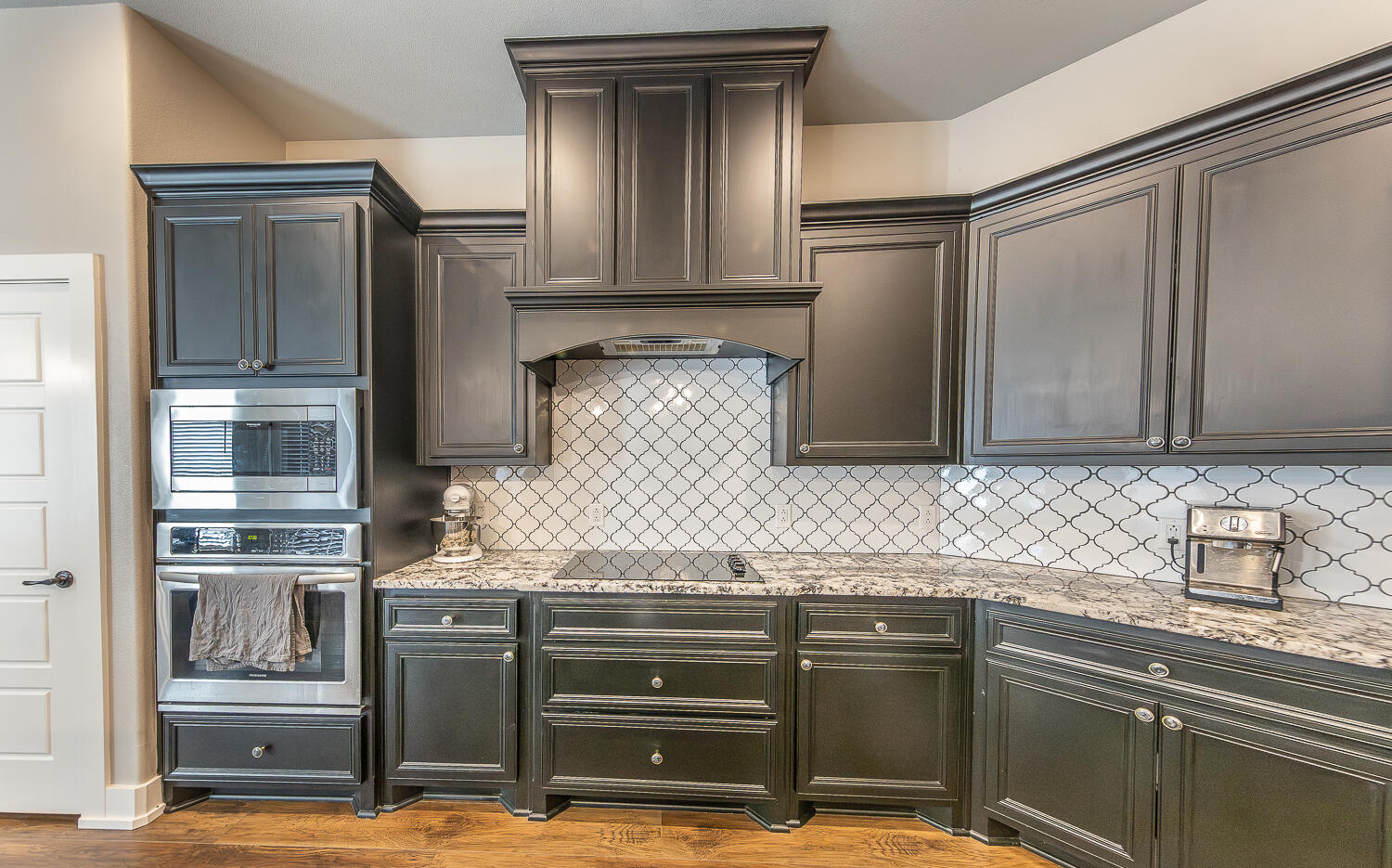 6961 103rd Street Lubbock, TX 79424 - Photo 9 of 32 a kitchen with granite countertop a refrigerator and a sink