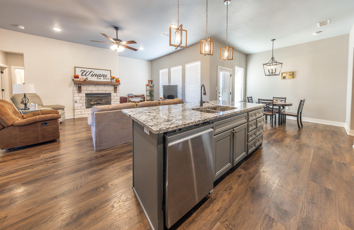 6961 103rd Street Lubbock, TX 79424 - Photo 10 of 32 a kitchen with stainless steel appliances granite countertop wooden floors and white cabinets