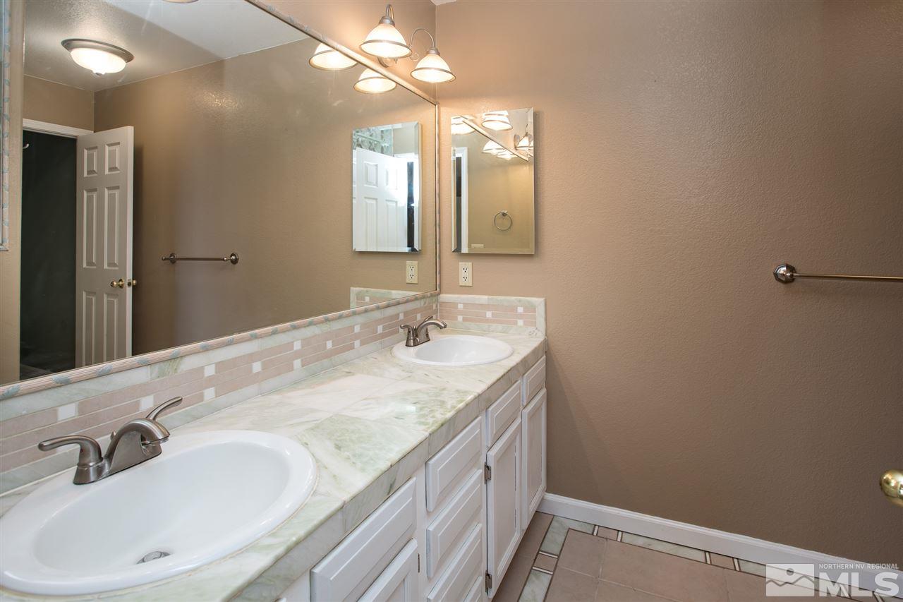 10475 Osage Road Reno, NV 89508 - Photo 12 of 25 a bathroom with a sink and a mirror