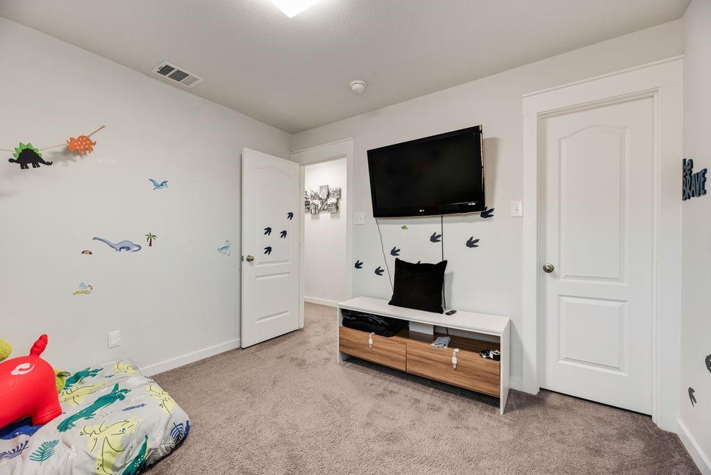 2702 Runnels Court Forney, TX 75126 - Photo 24 of 32 This room features light gray walls, a light gray carpet, and white trim around the doors and ceiling
