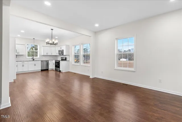 a view of kitchen and hall with wooden floor