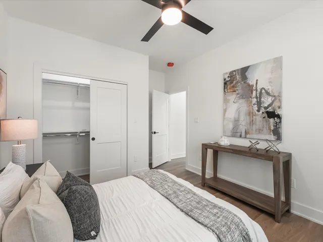 a bedroom with a bed and a chandelier