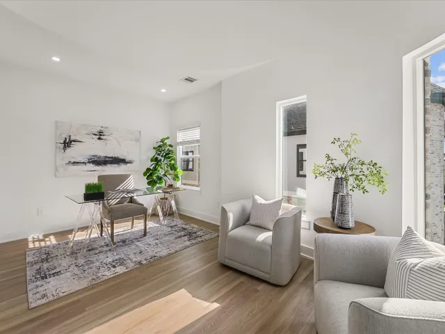 a living room with furniture and a potted plant