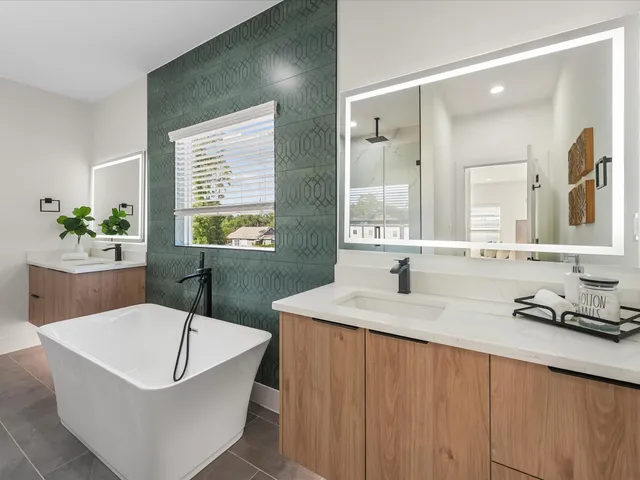 a bathroom with a tub sink and mirror