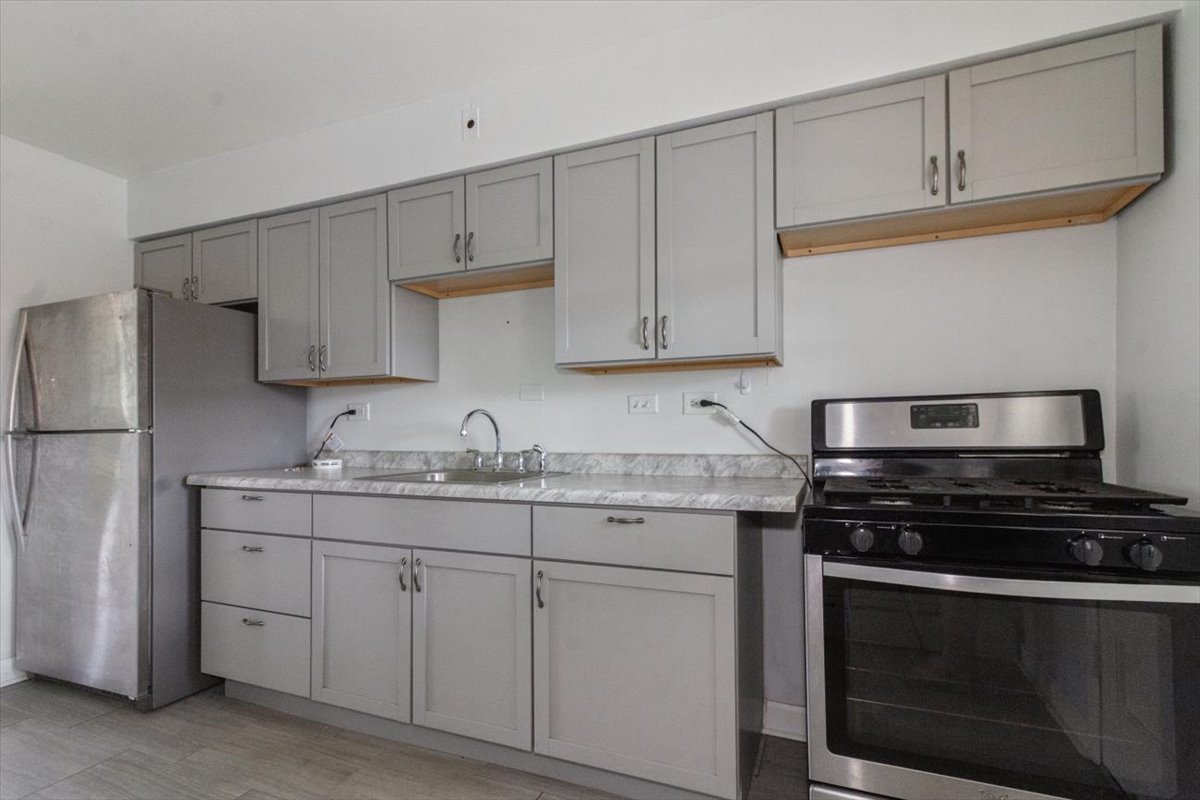 1211 Homestead Road La Grange Park, IL 60526 - Photo 12 of 18 a kitchen with stainless steel appliances granite countertop a stove a sink and a refrigerator