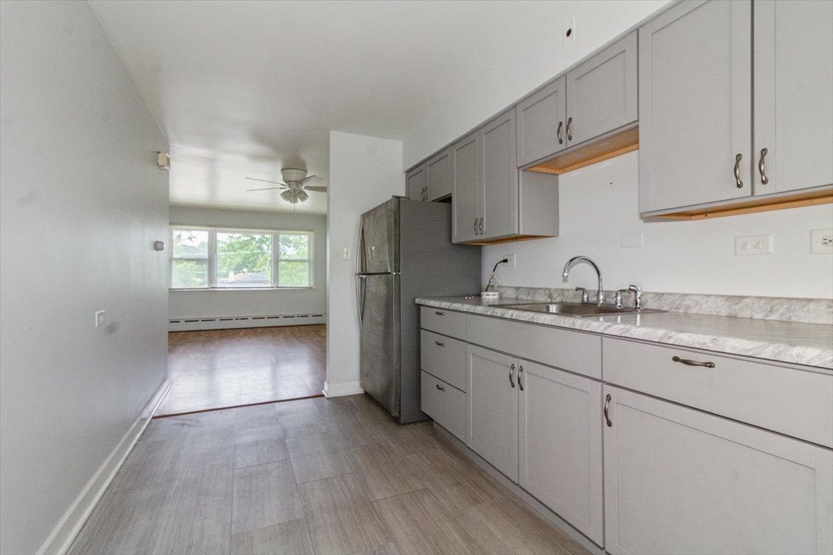 1211 Homestead Road La Grange Park, IL 60526 - Photo 13 of 18 a kitchen with granite countertop white cabinets and white appliances