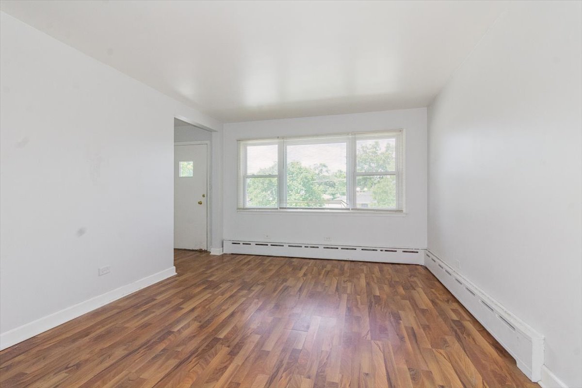 1211 Homestead Road La Grange Park, IL 60526 - Photo 6 of 18 an empty room with wooden floor and windows