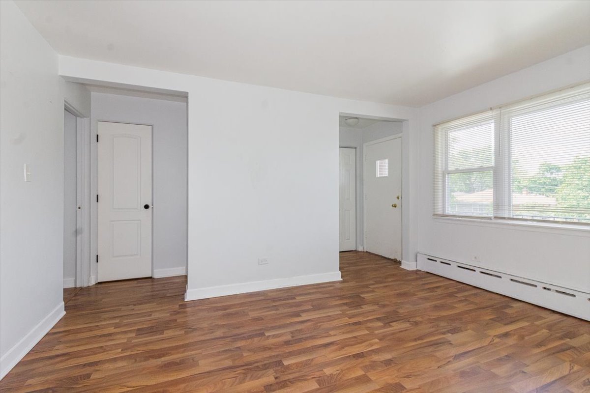 1211 Homestead Road La Grange Park, IL 60526 - Photo 7 of 18 a view of an empty room with wooden floor and a window