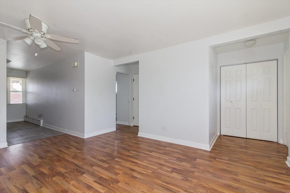 1211 Homestead Road La Grange Park, IL 60526 - Photo 8 of 18 a view of an empty room with wooden floor and a ceiling fan